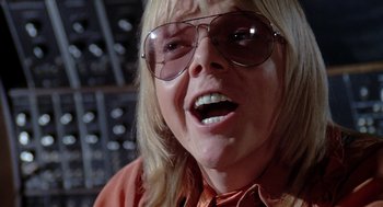 Movie still from “Phantom of the Paradise” (1974), directed by Brian De Palma – A person wearing glasses; Close Up shot, Low angle