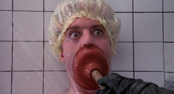 Movie still from “Phantom of the Paradise” (1974), directed by Brian De Palma – A person with a hat on and a stick in his mouth; Close Up shot, Low angle