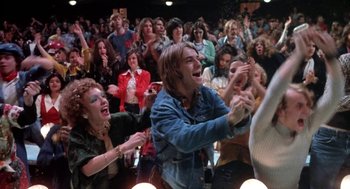 Movie still from “Phantom of the Paradise” (1974), directed by Brian De Palma – A group of people in a room clapping; Medium shot, Low angle