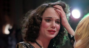 Movie still from “Phantom of the Paradise” (1974), directed by Brian De Palma – A person holding their head; Close Up shot, High angle