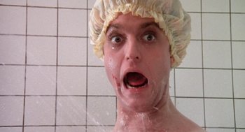 Movie still from “Phantom of the Paradise” (1974), directed by Brian De Palma – A man in a shower wearing a shower cap; Close Up shot, Low angle