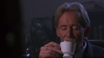 Movie still from “Phantoms” (1998), directed by Joe Chappelle – A person drinking a cup of coffee; Close Up shot, Low angle