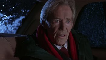Movie still from “Phantoms” (1998), directed by Joe Chappelle – An older man wearing a green jacket and a red scarf; Close Up shot, Over the shoulder angle