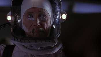 Movie still from “Phantoms” (1998), directed by Joe Chappelle – An old man wearing a space suit and helmet; Close Up shot, Low angle