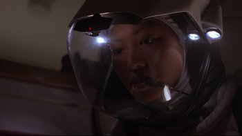 Movie still from “Phantoms” (1998), directed by Joe Chappelle – A person wearing a helmet with a light on it; Close Up shot, Low angle