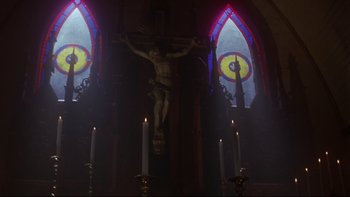 Movie still from “Phantoms” (1998), directed by Joe Chappelle – A crucifixion statue in a church with candles; Extreme Close Up shot, Low angle