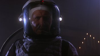 Movie still from “Phantoms” (1998), directed by Joe Chappelle – An older man wearing a space suit and a helmet; Close Up shot, Low angle