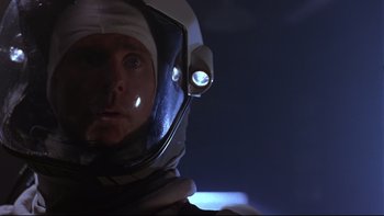 Movie still from “Phantoms” (1998), directed by Joe Chappelle – A man in a space suit with a helmet on; Close Up shot, Low angle