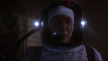 Movie still from “Phantoms” (1998), directed by Joe Chappelle – An older man wearing a space suit and a helmet; Close Up shot, Low angle