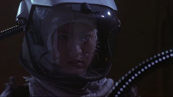 Movie still from “Phantoms” (1998), directed by Joe Chappelle – A person in a spacesuit with a helmet on; Close Up shot, Low angle