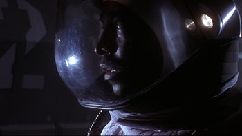 Movie still from “Phantoms” (1998), directed by Joe Chappelle – A person wearing a space helmet; Close Up shot, Low angle