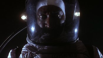 Movie still from “Phantoms” (1998), directed by Joe Chappelle – A person wearing a space suit; Close Up shot, Low angle