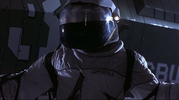 Movie still from “Phantoms” (1998), directed by Joe Chappelle – A person wearing a spacesuit; Medium shot, Low angle
