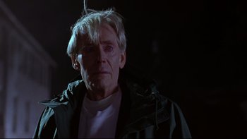 Movie still from “Phantoms” (1998), directed by Joe Chappelle – An older man with white hair is looking at the camera; Close Up shot, Low angle