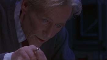 Movie still from “Phantoms” (1998), directed by Joe Chappelle – An older man with a ring in his hand looking down; Close Up shot, Low angle