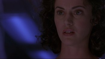 Movie still from “Phantoms” (1998), directed by Joe Chappelle – A woman's face in front of a blurry background; Close Up shot, Low angle