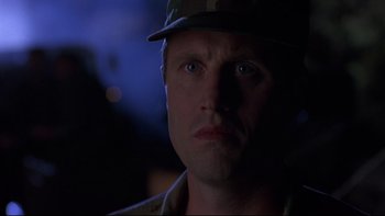 Movie still from “Phantoms” (1998), directed by Joe Chappelle – A person wearing a hat; Close Up shot, Low angle