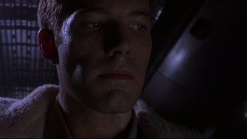 Movie still from “Phantoms” (1998), directed by Joe Chappelle – A man's face in the dark; Close Up shot, Low angle