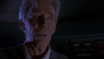 Movie still from “Phantoms” (1998), directed by Joe Chappelle – An older man with white hair and blue eyes stares at the camera; Close Up shot, Low angle
