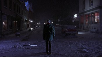 Movie still from “Phantoms” (1998), directed by Joe Chappelle – A person standing in the middle of a street at night; Wide shot, Low angle