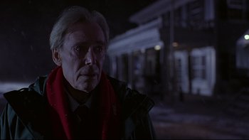 Movie still from “Phantoms” (1998), directed by Joe Chappelle – An older man wearing a black jacket and a red scarf; Close Up shot, Low angle