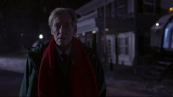 Movie still from “Phantoms” (1998), directed by Joe Chappelle – An older man wearing a red scarf and a black jacket; Medium shot, Low angle