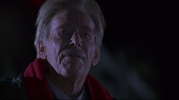 Movie still from “Phantoms” (1998), directed by Joe Chappelle – An old man with a beard and a red robe; Close Up shot, Low angle