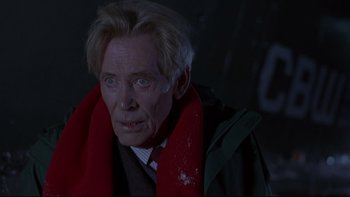 Movie still from “Phantoms” (1998), directed by Joe Chappelle – An older man wearing a jacket and a red scarf; Close Up shot, Low angle