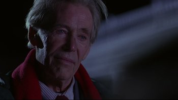 Movie still from “Phantoms” (1998), directed by Joe Chappelle – An older man wearing a suit and red tie; Close Up shot, Over the shoulder angle
