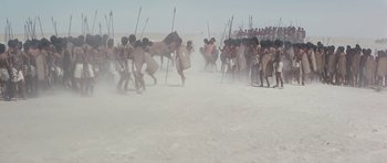 Movie still from “Pharaoh” (1966), directed by Jerzy Kawalerowicz – A group of people are running in the sand; Extreme Wide shot, High angle