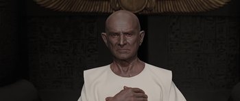 An old man with a bald head wearing a white t - shirt