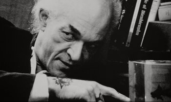 Movie still from “Pi” (1998), directed by Darren Aronofsky – An older man with a tattoo on his arm; Close Up shot, Low angle