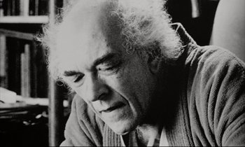 Movie still from “Pi” (1998), directed by Darren Aronofsky – An older man with white curly hair looking down; Close Up shot, Low angle