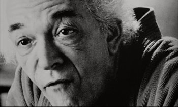 Movie still from “Pi” (1998), directed by Darren Aronofsky – An older man with a beard and a mustache; Close Up shot, Low angle