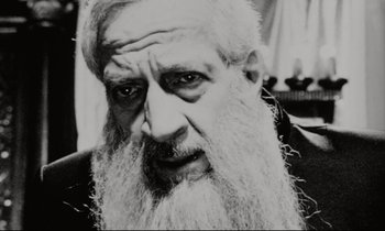 Movie still from “Pi” (1998), directed by Darren Aronofsky – An old man with a long white beard; Close Up shot, High angle