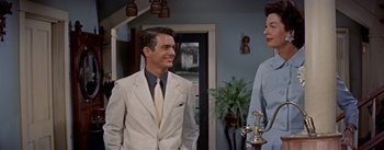 Movie still from “Picnic” (1955), directed by Joshua Logan – A man and a woman standing next to each other in a room; Medium shot, Over the shoulder angle