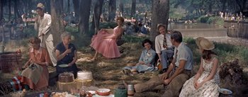 Movie still from “Picnic” (1955), directed by Joshua Logan – A group of people sitting in the grass; Wide shot, High angle