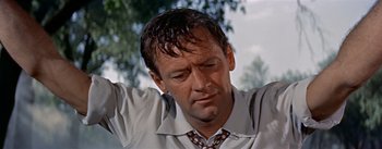 Movie still from “Picnic” (1955), directed by Joshua Logan – A person wearing a shirt and tie; Close Up shot, Low angle