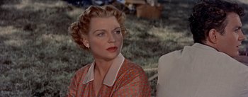 Movie still from “Picnic” (1955), directed by Joshua Logan – A woman in a red and white polka dot shirt; Close Up shot, Low angle