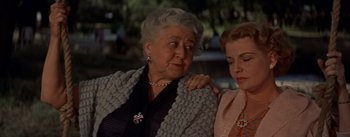 Movie still from “Picnic” (1955), directed by Joshua Logan – Two older women standing next to each other; Close Up shot, Low angle