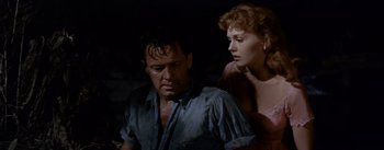 Movie still from “Picnic” (1955), directed by Joshua Logan – A man and a woman are sitting in a dark room; Medium shot, Low angle