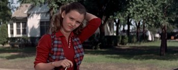 Movie still from “Picnic” (1955), directed by Joshua Logan – A young woman in a red shirt and a plaid shirt; Medium shot, Over the shoulder angle