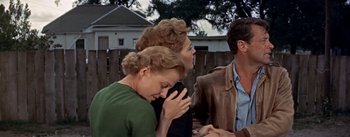 Movie still from “Picnic” (1955), directed by Joshua Logan – Two women and a man are praying together; Medium shot, Over the shoulder angle
