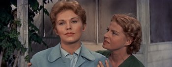 Movie still from “Picnic” (1955), directed by Joshua Logan – Two women are looking at each other in a scene from a movie; Close Up shot, Over the shoulder angle