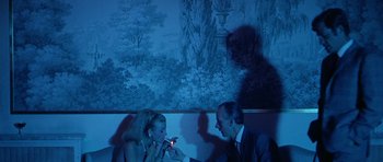 Movie still from “Pierrot le Fou” (1965), directed by Jean-Luc Godard – A man and a woman sitting at a dinner table; Medium shot, Low angle