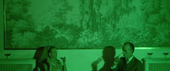 Movie still from “Pierrot le Fou” (1965), directed by Jean-Luc Godard – A man and a woman in front of a painting; Medium shot, Over the shoulder angle