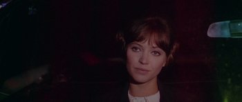 Movie still from “Pierrot le Fou” (1965), directed by Jean-Luc Godard – A person wearing a suit and tie; Close Up shot, Over the shoulder angle