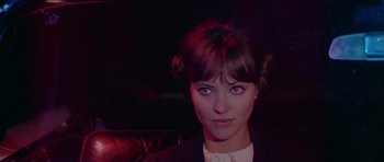 Movie still from “Pierrot le Fou” (1965), directed by Jean-Luc Godard – A person wearing a suit and tie; Close Up shot, Low angle