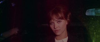 Movie still from “Pierrot le Fou” (1965), directed by Jean-Luc Godard – A person wearing a suit and tie; Close Up shot, High angle