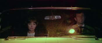 Movie still from “Pierrot le Fou” (1965), directed by Jean-Luc Godard – A woman looking out of the window of a car at night; Close Up shot, High angle